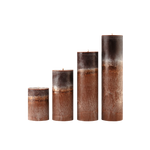 Set of four brown cylindrical candles with textured surface on a white background