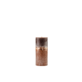 Decorative candle with a textured surface on a white background