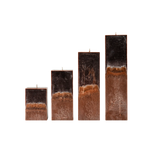 Set of four rectangular candles with a textured brown base on a white background