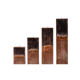 Set of four rectangular candles with a textured brown base on a white background