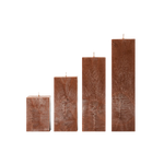 Set of four rectangular brown candles on a white background