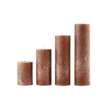Set of four brown textured candles on a white background