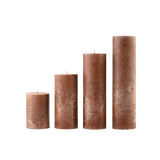 Set of four brown textured candles on a white background