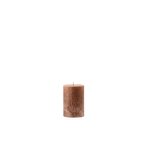 Brown textured candle on a white background