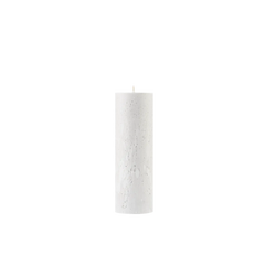 White pillar candle on a white background
