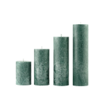 Set of four textured green candles on a white background