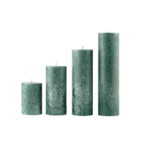 Set of four textured green candles on a white background