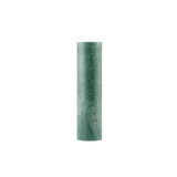 Green cylindrical candle on a white background