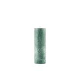 Green textured candle on a white background