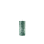Green textured candle on a white background