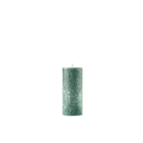 Green textured candle on a white background