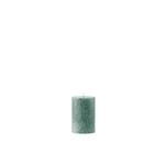 Green textured candle on a white background