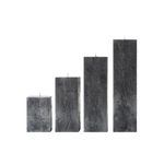 Set of four rectangular black candles on a white background