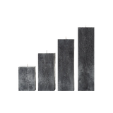 Set of four rectangular black candles on a white background