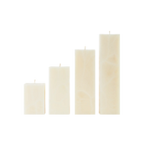 Set of four cream-colored rectangular candles on a white background