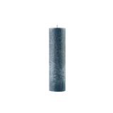 Textured blue candle on a white background