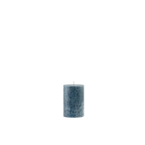 Textured blue candle on a white background