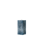 Blue textured square pillar candle on a white background