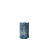 Blue textured square pillar candle on a white background