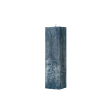 Textured blue candle on a white background