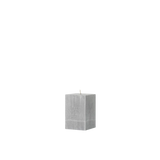 Gray textured cube candle on a white background