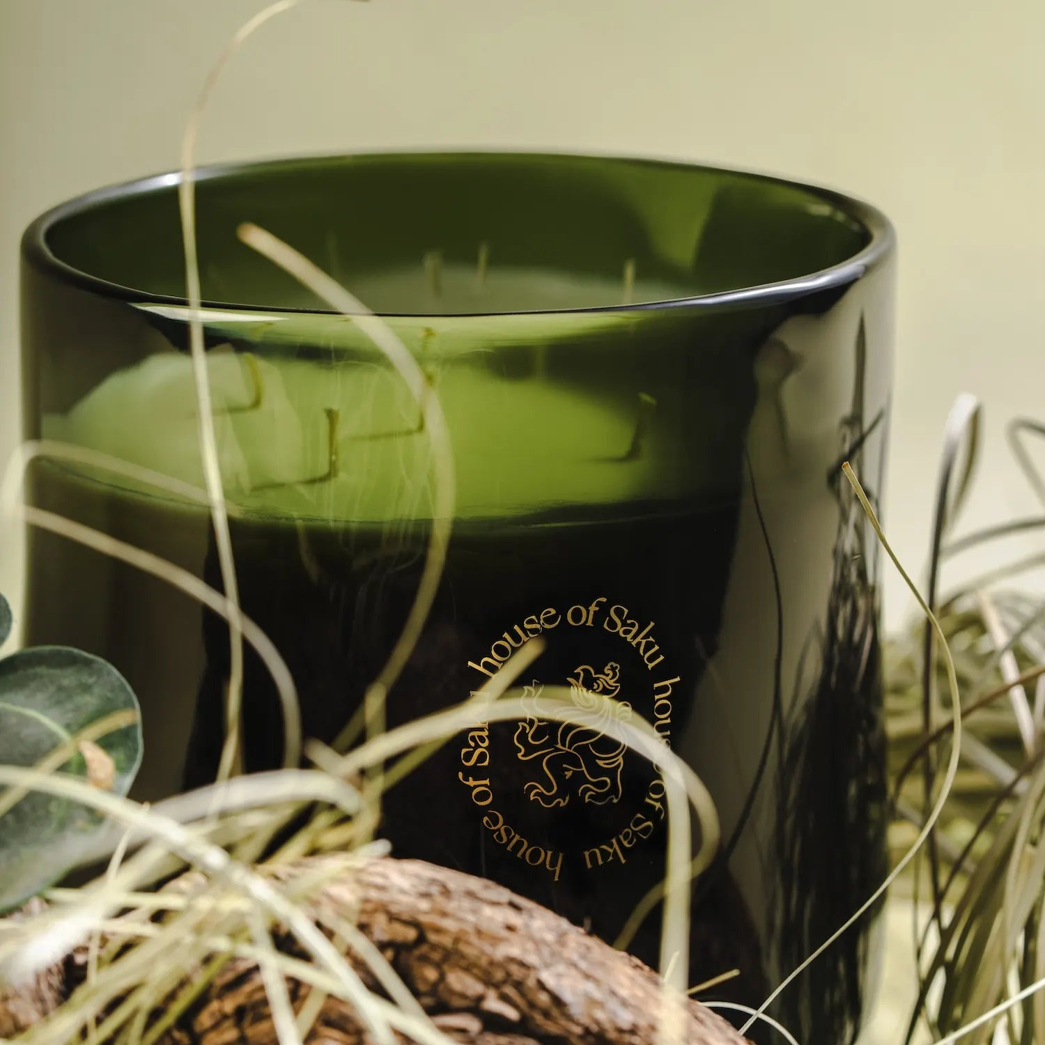 Black candle with gold text in a decorative setting