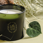Black candle with 'house of Saku' branding on a light background with a leaf.